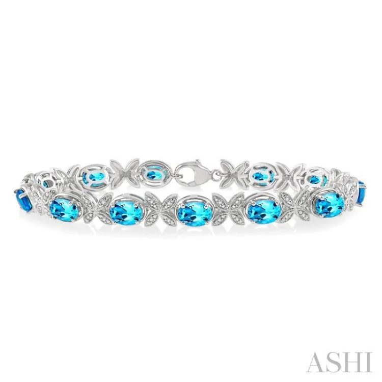 Ladies bracelets discount offers-1/10 Ctw Round Cut Diamond & 7x5MM Oval Cut Blue Topaz Semi Precious Bracelet in Sterling Silver