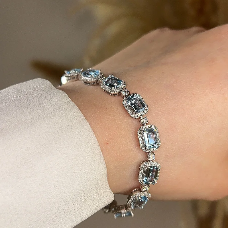 Ladies bracelets floral designs-Emerald Shape 11 Carat Aquamarine Tennis Bracelet Featuring Diamond Halo BRHAEC